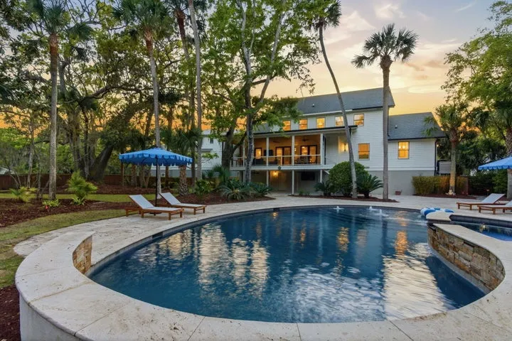 Pool and spa in a wooded backyard at 103 Oakview Lane, Isle of Palms, at dusk